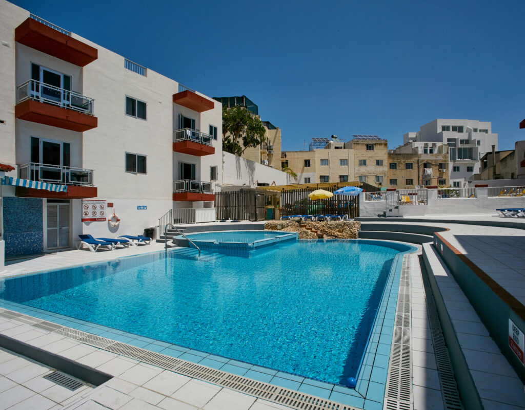 Clubclass Malta Pool- Garden View Apartments in the background